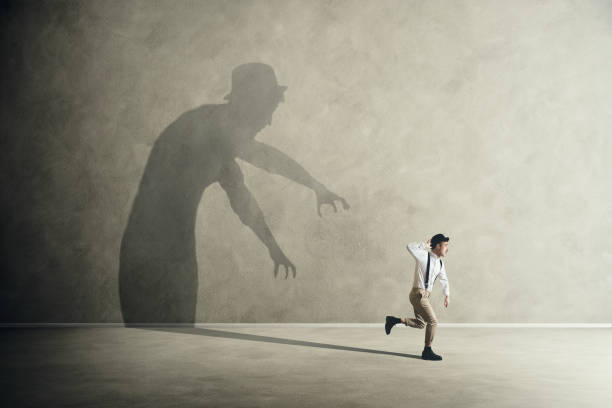 istock Terrified man ecapes from his scary fears shadows 862430744