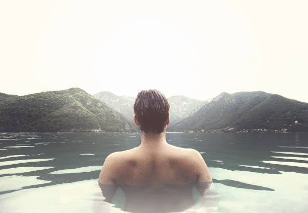 man relaxing in a natural hot bath