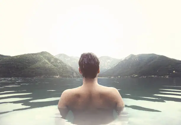 Photo of man relaxing in a natural hot bath