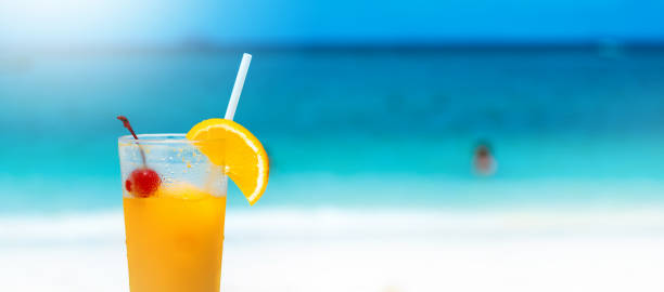 istock orange juice drink on the beach table, summer fresh cool water for relaxation, copy space. 862436672