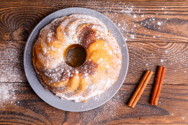 istock A large cupcake with cinnamon sticks on a wooden surface. 862437204