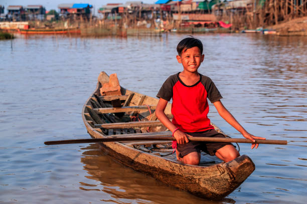 istock Cambodian young boy rowing a boat, Tonle Sap, Cambodia 862441794