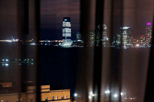 istock Looking at a cityscape from a see through curtain at night 862445984