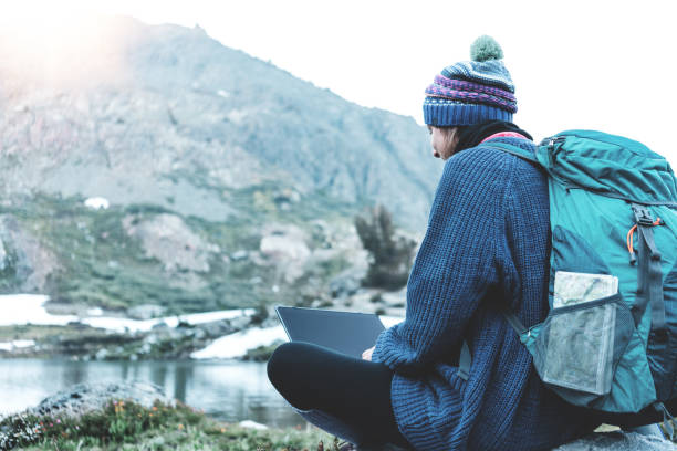 istock Woman using laptop in the wild 862449432