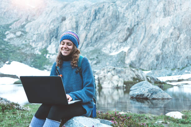 istock Woman using laptop in the wild 862449680