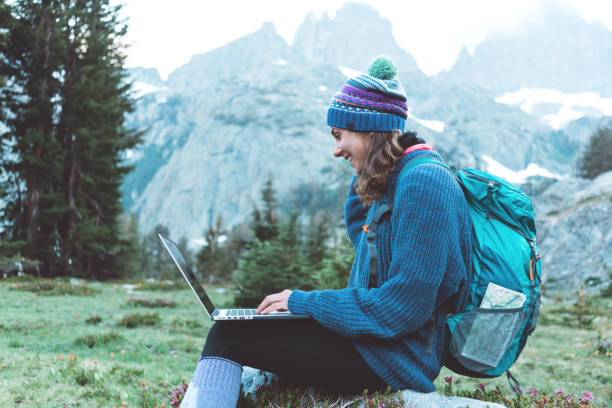 istock Woman using laptop in the wild 862449832