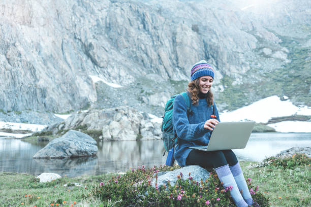 istock Woman using laptop in the wild 862449838