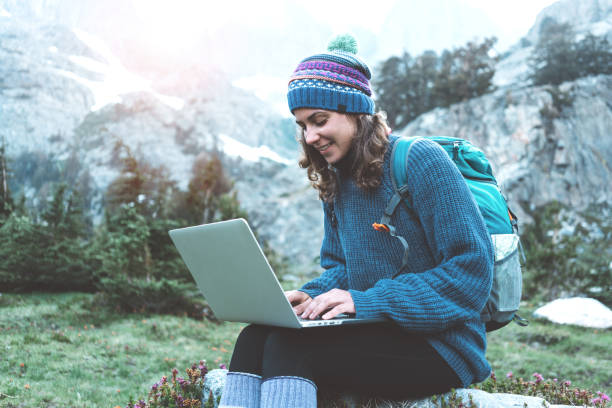 istock Woman using laptop in the wild 862450112
