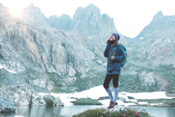 istock Happy traveler talking on the phone in wilderness 862452702