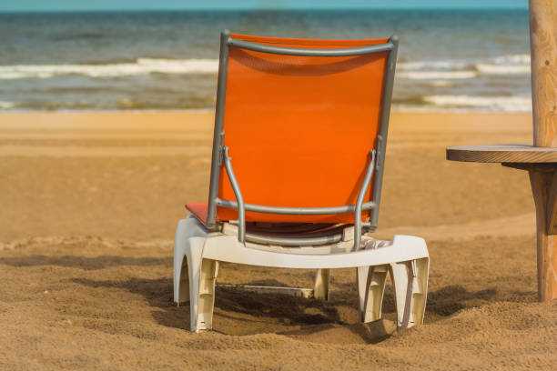 istock Horizon line with orange sun lounger on the gold beach. 862452976