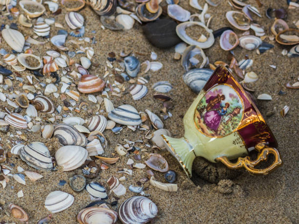istock Porcelain beautiful cup between seashells and sand 862453082