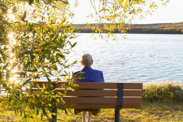 istock woman sitting on a prak bench 862453278