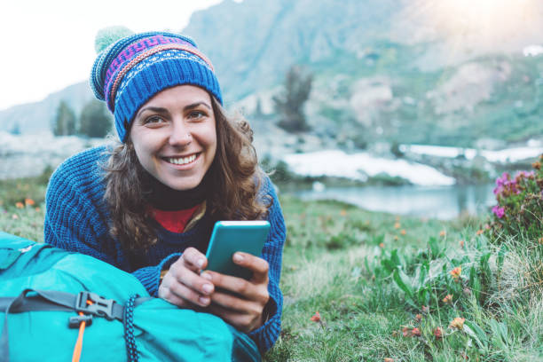 istock Happy traveler texting and chatting on the mobile phone in wilderness 862457806