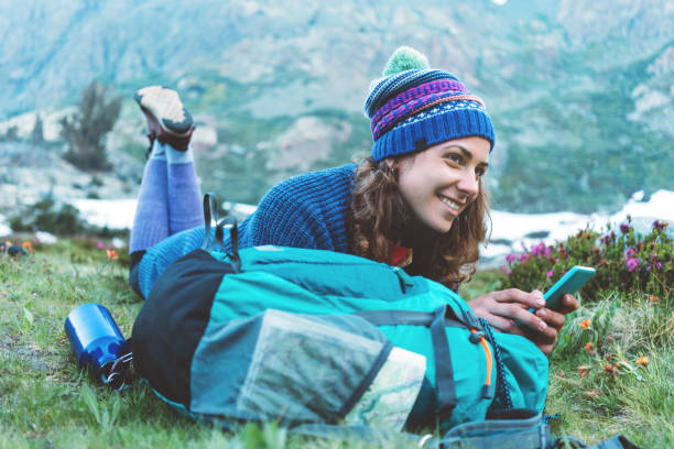 istock Happy traveler texting and chatting on the mobile phone in wilderness 862458160