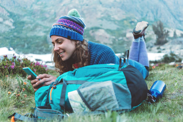 istock Happy traveler texting and chatting on the mobile phone in wilderness 862458164