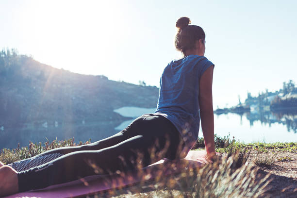 young girl practicing yoga in wild