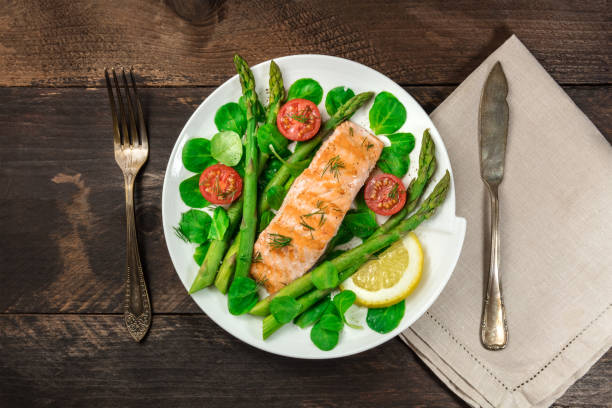 istock Grilled salmon with asparagus, green salad, and copyspace 862464944