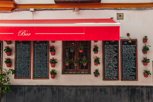 Seville, Spain. 16 September 2017 - The facade of one of the hundres of typical bars restaurants in Seville, Spain. This one includes blackboards with the dishes they offer.