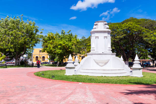 View of monument celebrating the city's 400th anniversary, and the activity at mid-day, on San Martin Park, in downtown Campeche