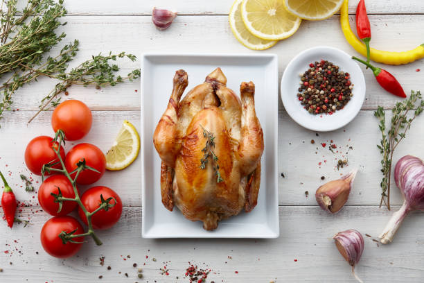 Roasted chicken with herbs and spices for holiday dinner Roasted chicken with herbs and spices for Christmas or Thanksgiving holiday dinner, top view turkey thanksgiving dinner cooked stock pictures, royalty-free photos & images