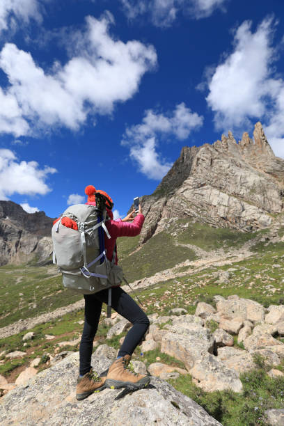 istock successful woman hiker use smartphone in mountain top rock 862507486