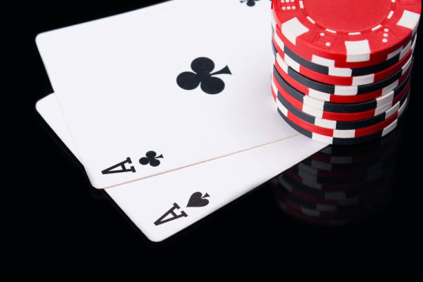 istock high bet of red chips on the game cards, on black reflection 862508866
