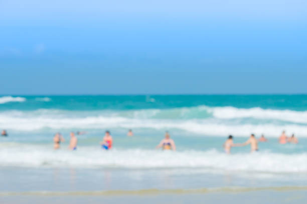 Crowd of people enjoy swimming in a sunny day at tropical beach ,beach holiday concept.