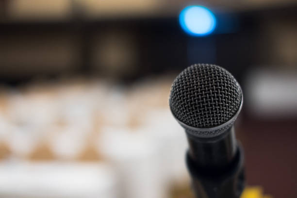 istock microphone in modern conference hall interior with white chairs. seminar room with empty seat. business event 862511314