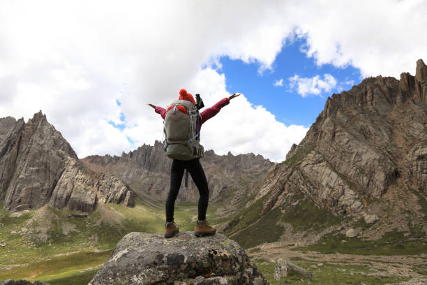istock cheering successful woman hiker on mountain top 862518682
