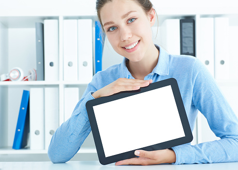 young woman showing a dgital tablet display - Portrait of a funny girl holding a tablet PC