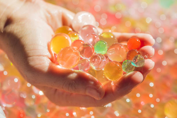istock Colored balls of water beads, hydrogel in in hands. Sensory experiences 862522560