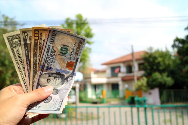 istock Money on hand with property house background 862525064
