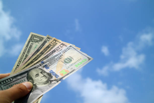 istock Money cash on hand with blue sky background 862525068