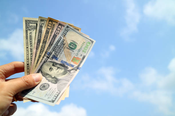 istock Money cash on hand with blue sky background 862525070