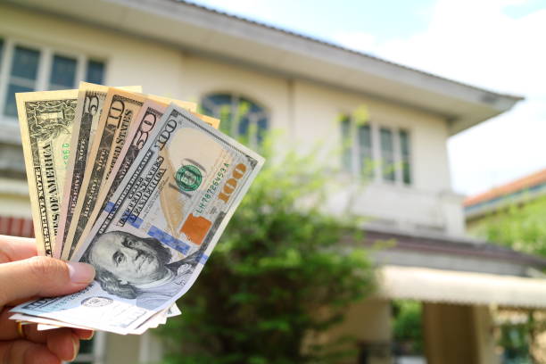 istock Money on hand with property house background 862525072