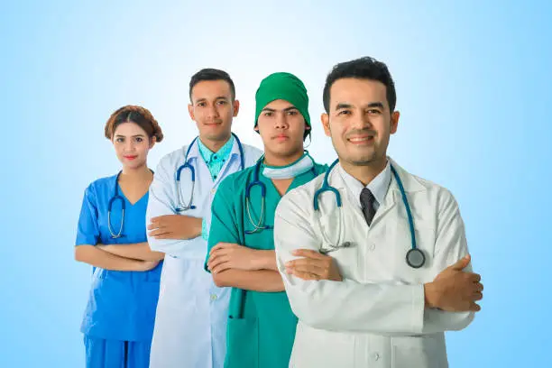 Team of doctor and nurse posing arms-crossed expressing positive emotions with stethoscopes. isolated on blue background.