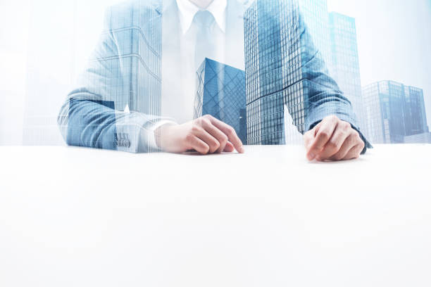 istock Businessman at Desk with Double Exposure Cityscape 862525634