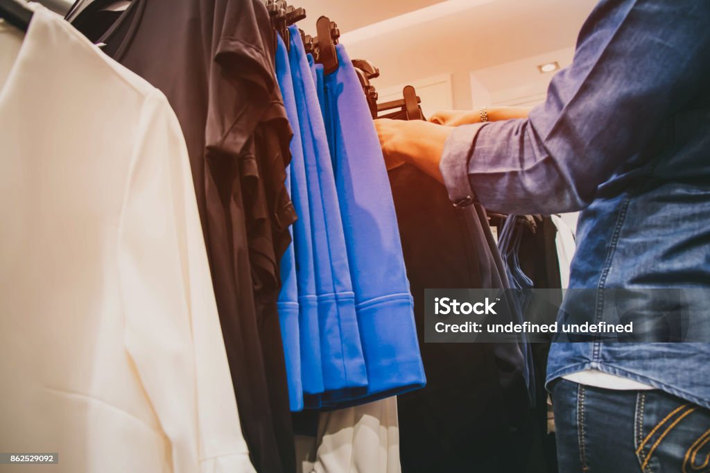 shopping a woman choose some clothes. Adult Stock Photo