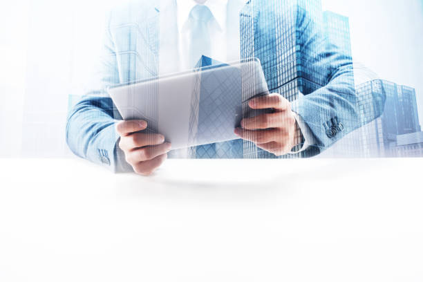 istock Businessman Using Digital Tablet with Double Exposure Cityscape 862529180
