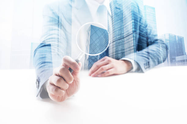 istock Businessman Holding a Magnifying Glass with Double Exposure Cityscape 862529806