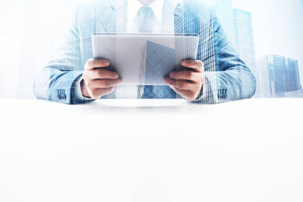 istock Businessman Using Digital Tablet with Double Exposure Cityscape 862531854