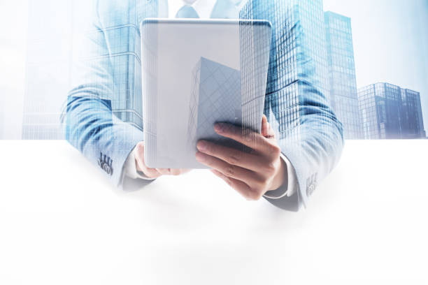 istock Businessman Using Digital Tablet with Double Exposure Cityscape 862531870