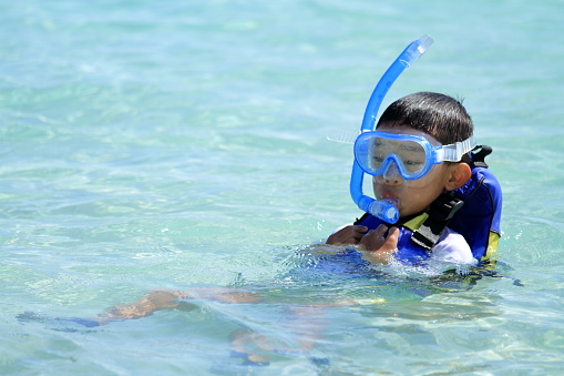 Japanese boy swimming with snorkel (second grade at elementary school)