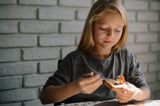 istock Cute blond girl preapring breakfast 862534624