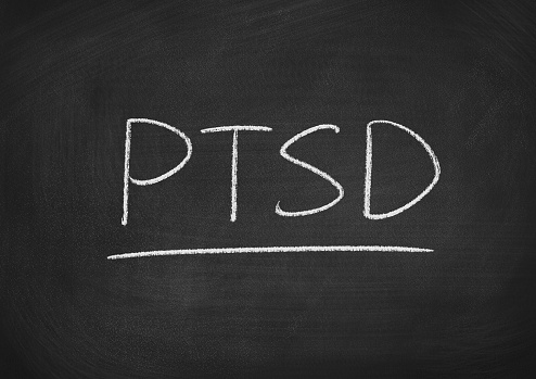 ptsd concept word on a blackboard background