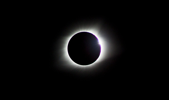 As totality comes to an end, Baily's Beads can be seen transitioning into the Diamond Ring before the sun brightens the sky once more.