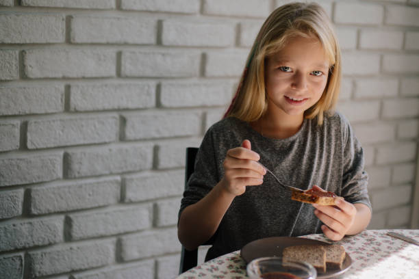 istock Girl eating bread and jam 862541938