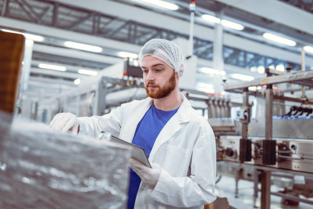 istock Young Handsome Man Reading Instruction Manual For New Machine 862544940