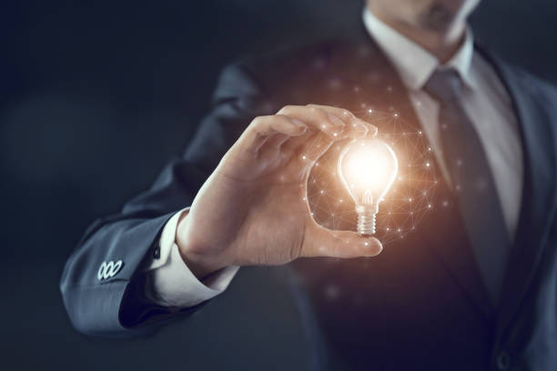 istock Businessman holding illuminated light bulb, idea, innovation and inspiration concept. 862545698