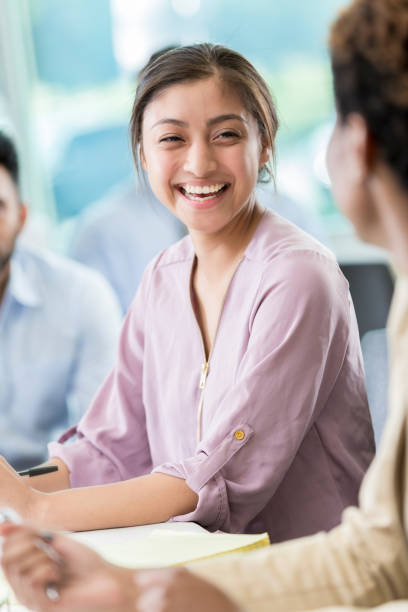 istock Female Hispanic business student laughs with fellow student before class 862545712